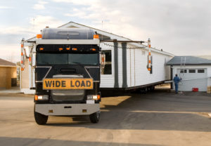 Semi-Truck backing in a mobile home.
